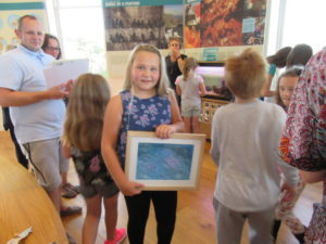 Iona Gillie, our art competition overall winner, with a framed print of her picture.